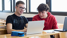Nois consultant els seus laptops