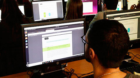 Un estudiant amb un ordinador fent un exercici