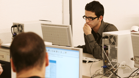 Young man looking at a computer screen