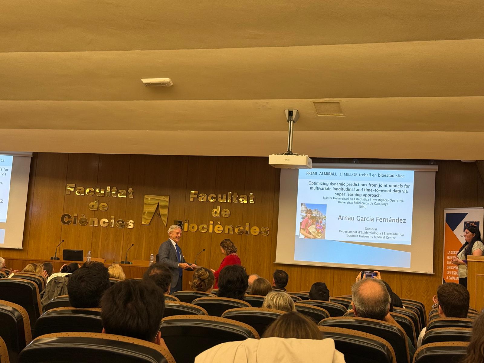 Daniel Peña lliurant el certificat a Guadalupe Gómez, en representació d'Arnau Garcia guanyador del premi Almirall al millor treball de bioestadística