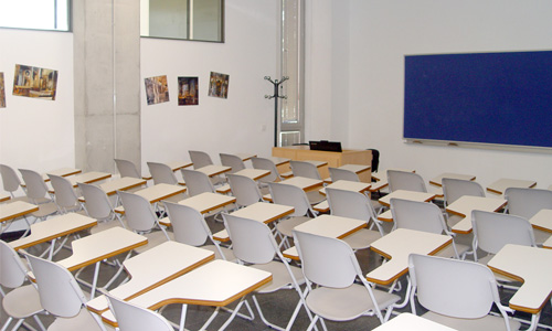 A room full of chairs and a blue board.